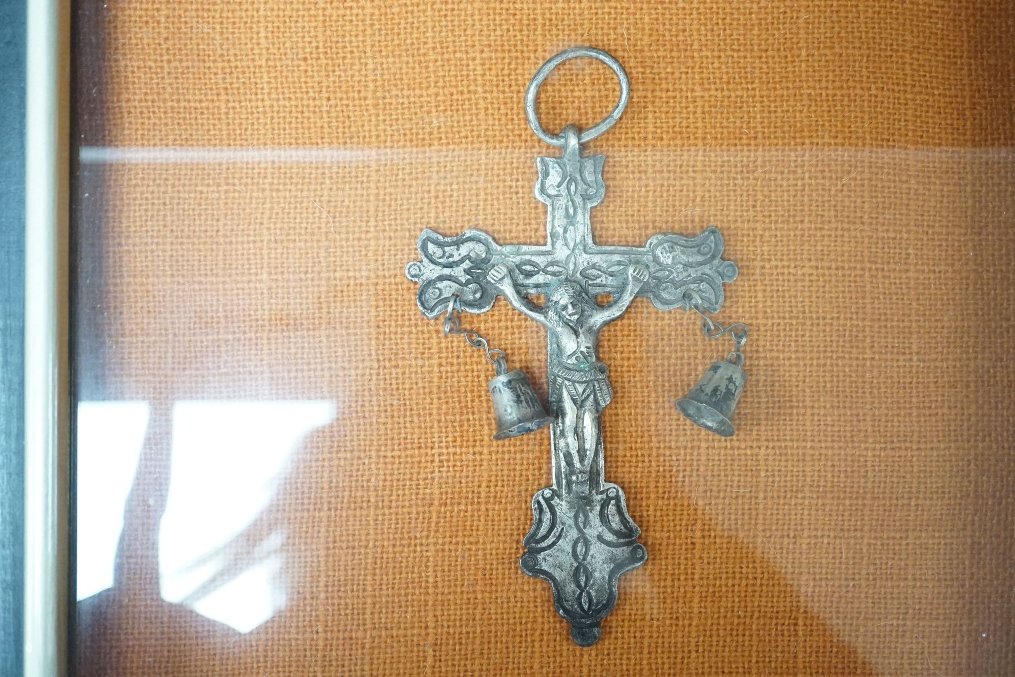 A carved crucifix and a framed metal Peruvian colonial crucifix, 50cm